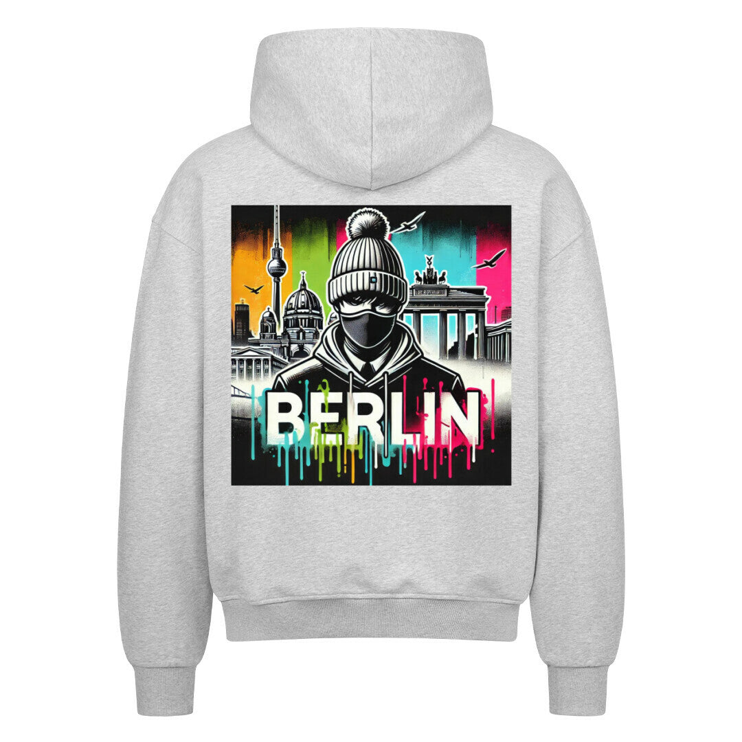 Stylischer grauer Berlin Hoodie mit buntem Stadtbild-Design auf der Rückseite.
